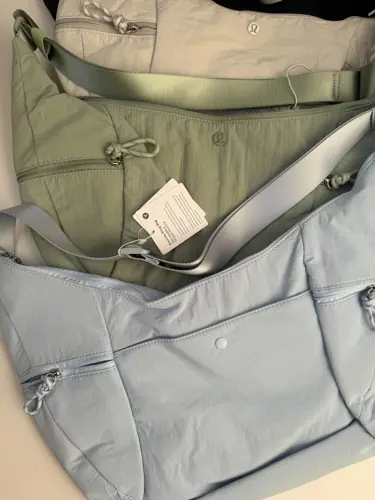 کیف اسلوچی اسلینگ 13 لیتری Lululemon، کیف‌های اسلینگ مشکی، کرم، زیتونی و آبی روشن با جیب بیرونی روی سطح روشن