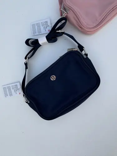 کراس بادی کمرا بگ 2 لیتری Lululemon، دو کیف مستطیلی سرمه‌ای و صورتی با دو زیپ و بند پهن، روی زمینه روشن - تصویر اصلی