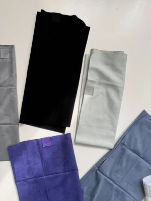 حوله کوچک Lululemon سبز سیج و مشکی؛ نمای لوگوی گوشه در کنار بنفش و آبی‌خاکستری